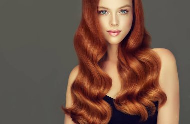 Hacimli saçlı Genç, Kızıl saçlı kadın. Uzun, yoğun, kıvırcık saç modeli ile güzel model .
