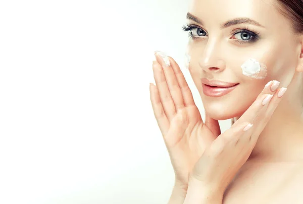 Beautiful Young Woman Applying Cosmetic Cream Treatment Her Face Isolated — Stock Photo, Image