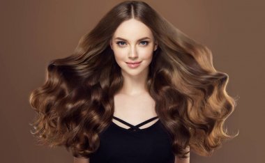 Uzun ve parlak dalgalı saçlı güzellik kız . Kıvırcık saç modeli ile güzel kadın modeli