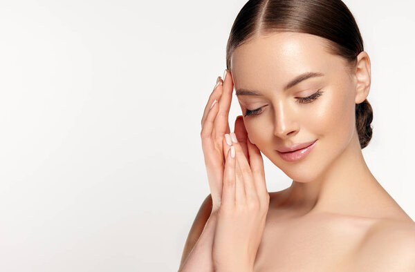 Beautiful young woman with clean fresh skin on face . Girl facial treatment . Cosmetology , beauty and spa