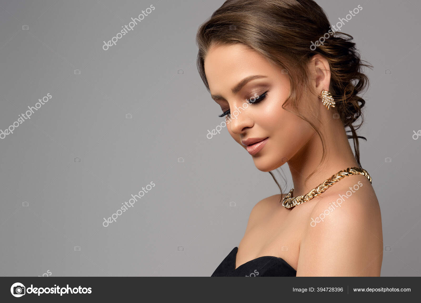 Beautiful girl with set jewelry . Woman in a necklace with a ring