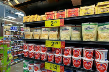Portland, Oregon - May 14, 2018 : Cheese and dairy products on display at Fred Meyer market in Portland clipart