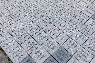 Gimhae, South Korea - July 12, 2018 : Tiles with letters at Bongha Village memorial park, 16th President of Korea, Roh Moo-hyun in Gimhae city clipart
