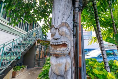 Honolulu, Hawaii - Dec 25, 2018 : Ancient Polynesian style tiki wooden carvings in Waikiki beach clipart