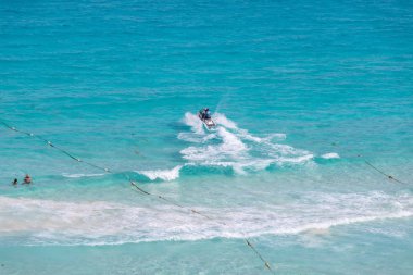 Jetskiing in Caribbean Sea, Cancun beach clipart