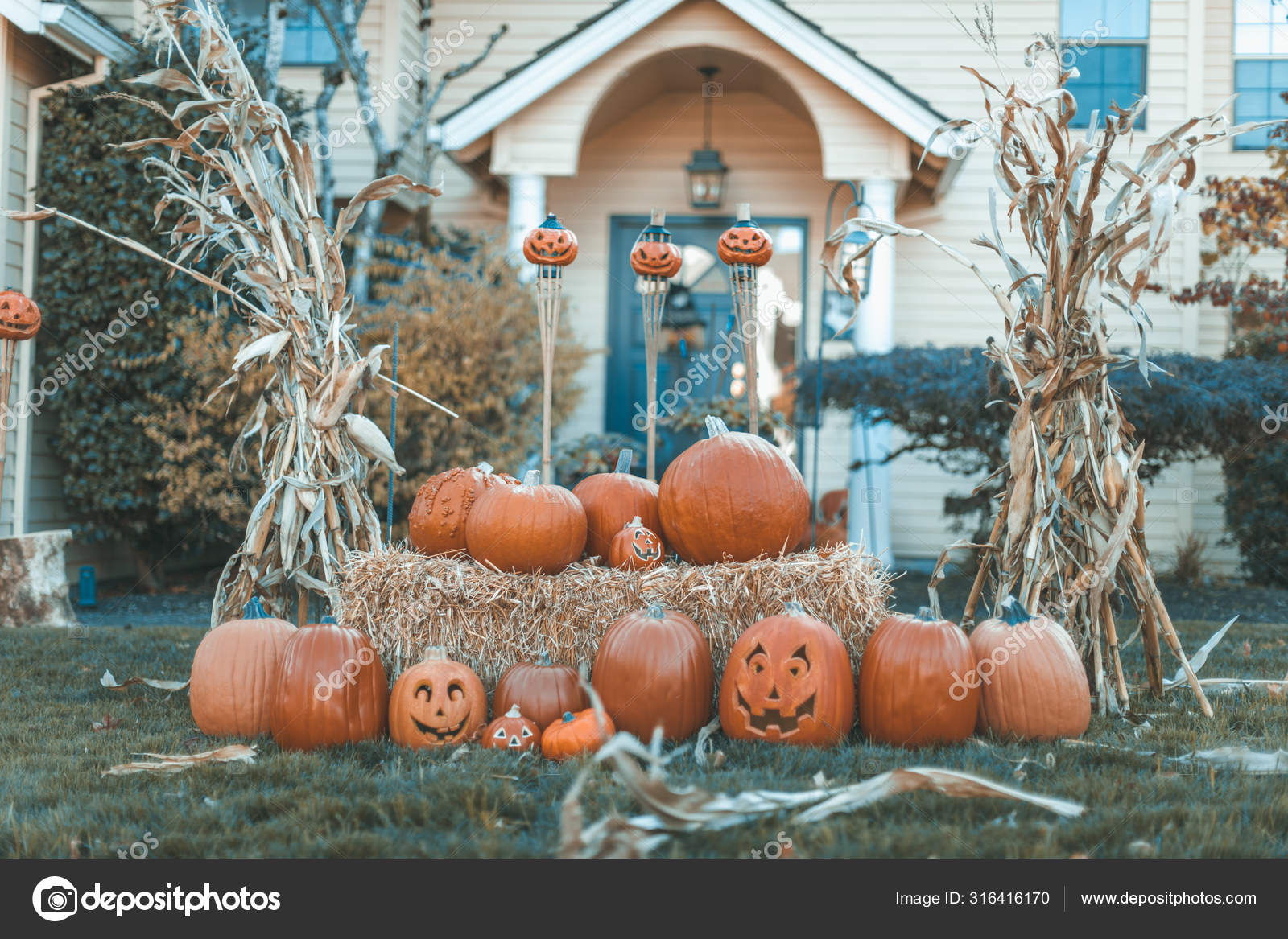 Halloween outdoor pumpkin decorations in front of house yard Stock