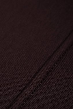 Düzgün dikişli koyu kahverengi kumaş. Pamuk.