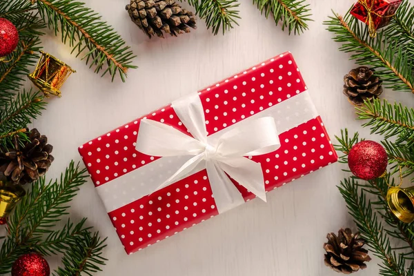 Świąteczny prezent w czerwony papier z białe groszki i duży biały kokarda — Zdjęcie stockowe