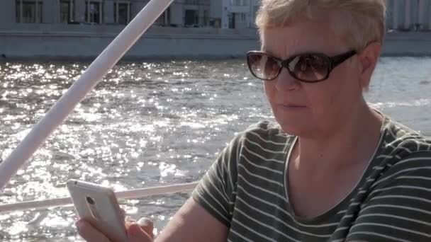 Κοντινό Πλάνο Ώριμη Γυναίκα Κάθεται Μια Βάρκα Και Κρατώντας Smartphone — Αρχείο Βίντεο