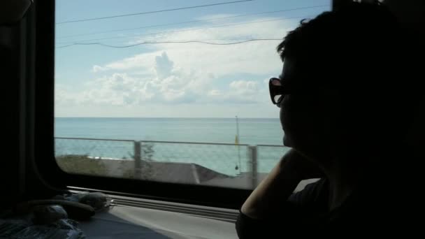 Silhouette Woman Wearing Sunglasses Looking Window Train Cabin Sunny Sea — Stock Video