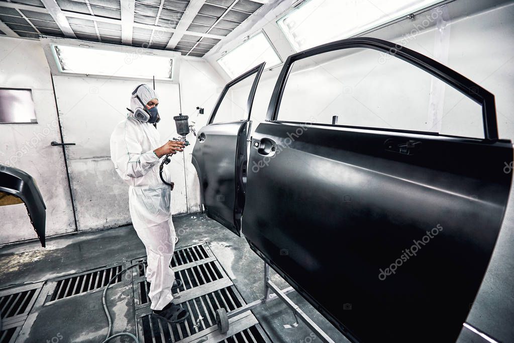 Restoration painting of a black car in the service center.