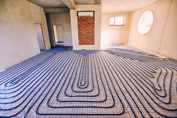 Laying pipes for floor heating at the construction site of the h