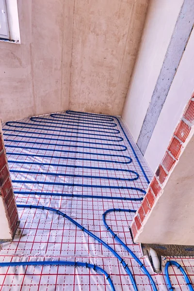 Laying pipes for floor heating at the construction site of the h