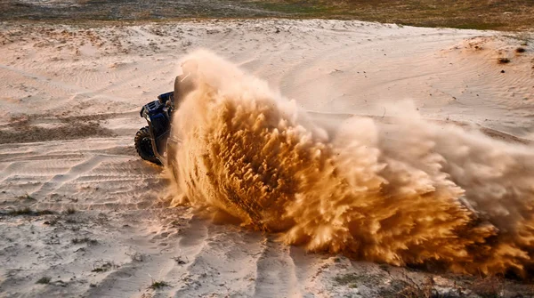 Racing in the sand on a four-wheel drive quad. — Stock Photo, Image