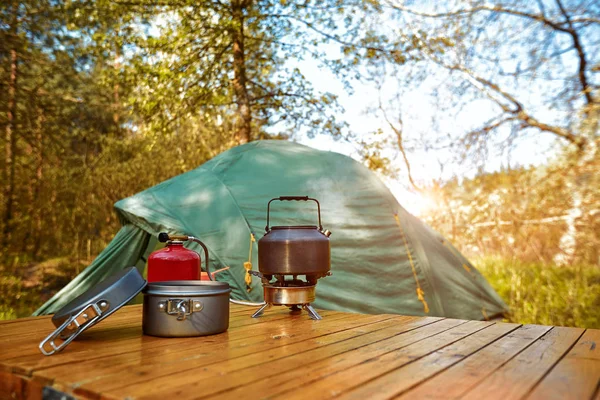Camping in the woods with a backpack and a tent on the banks of