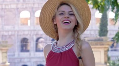beautiful woman with hat turns her head and laughs-Rome, Italy