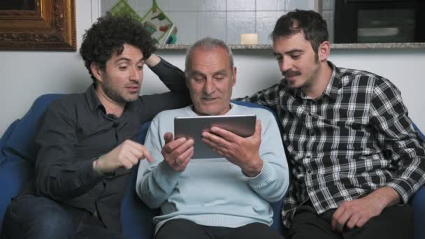 Sons Helping Old Father Use Digital Tablet Home — Stock Video