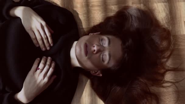 うつ病と物思いにふける女性敷設上の床だけで暗闇の中でのクローズ アップ — ストック動画