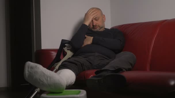 Pensive Sad Mature Man Broken Leg Alone Couch — Stock Video