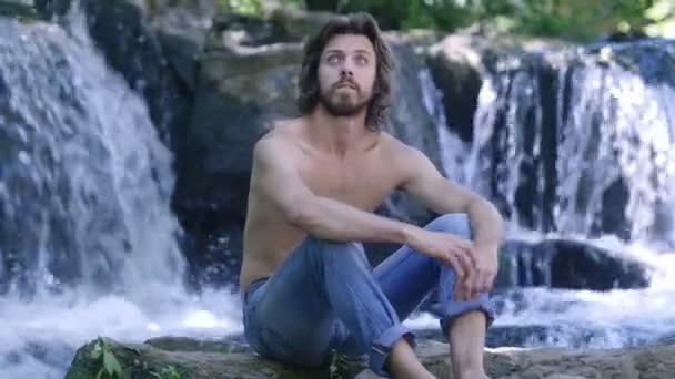 Bearded Man Sitting Rock Waterfall — Stock Video