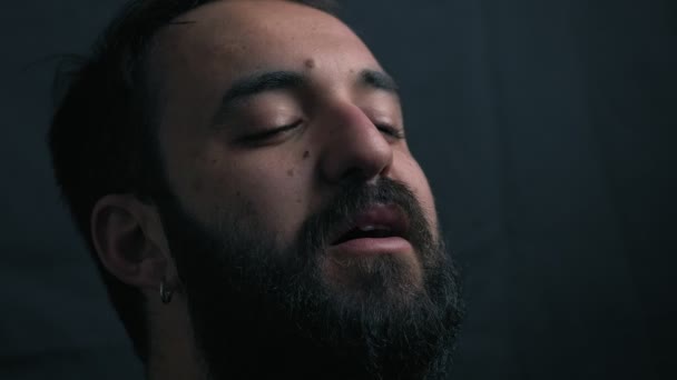 Young Bearded Man Crying Praying Darkness — Stock Video