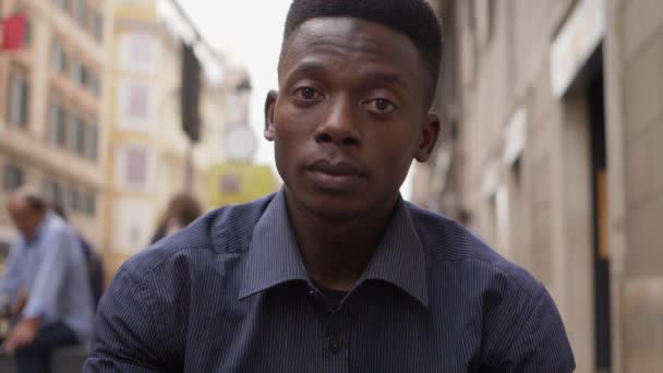 悲伤沮丧的年轻黑人非洲男子盯着相机在街上 — 图库视频影像