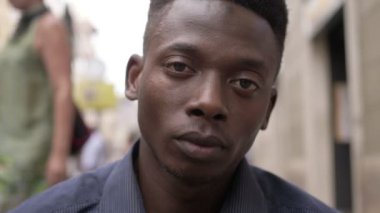 kameraya bakarak üzgün genç siyah Afrika göçmen sokak,