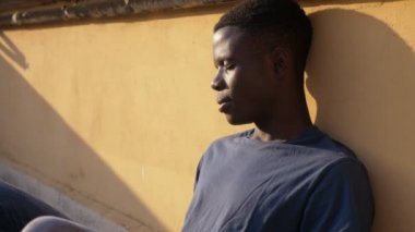 young African man sleeping in the sun suddenly wakes up.Nightmares, awakening