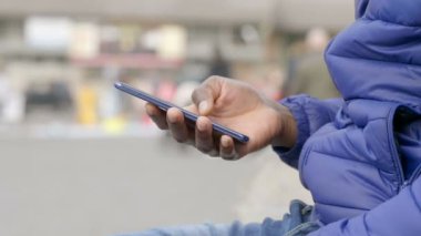 Şehirde akıllı telefon kullanan Afrikalı Amerikalı adam..