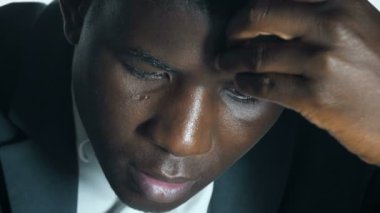 Düşünceli yakışıklı siyahi Afrikalı iş adamı ofisinde düşünüyor.