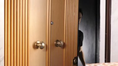 Genç adam ona pizza getiren kadın kuryeye kapıyı açıyor.