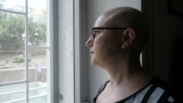 Pensive Bald Woman Looks Thoughtfully Out Window — 图库视频影像