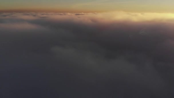 Aerial shot above thick clouds upper surface against horizon Royalty Free Stock Footage