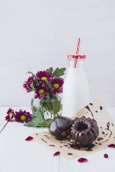 A delicious breakfast. Milk with cakes on a white table