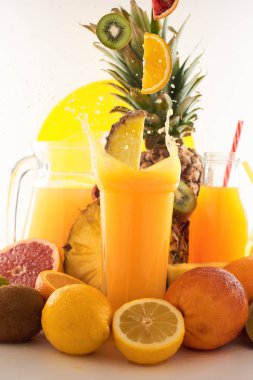 Taze meyve suyu dinamik sıçrama. Beyaz bir arka planda bir bardak meyve içeceği ve meyve. Lezzetli, lezzetli, tatlı yaz seti. 