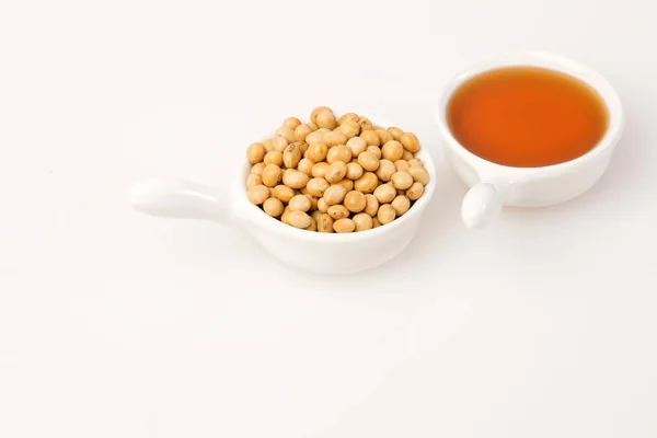 Oil and soybeans - Glycine max. White background