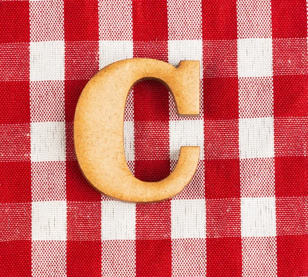 Letter C of the alphabet - Red checkered fabric tablecloth.