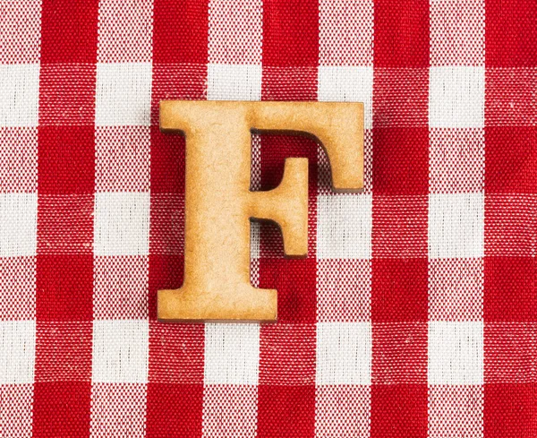 Letter F of the alphabet - Red checkered fabric tablecloth.