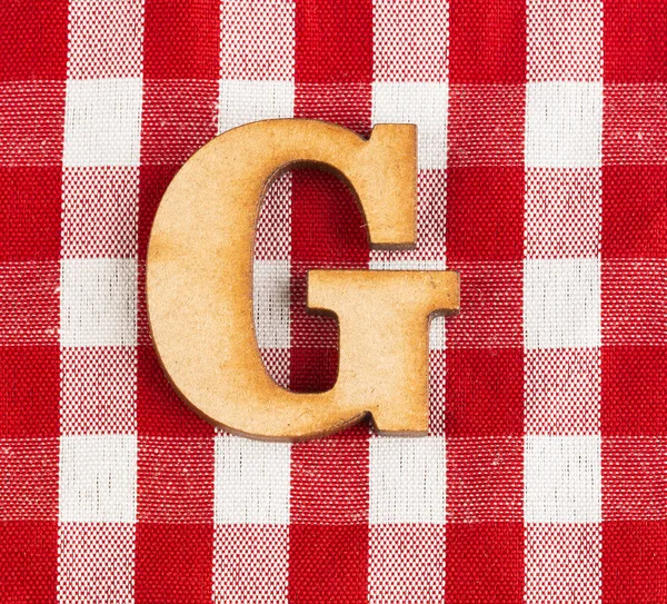 Letter G of the alphabet - Red checkered fabric tablecloth.