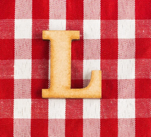 Letter L of the alphabet - Red checkered fabric tablecloth.