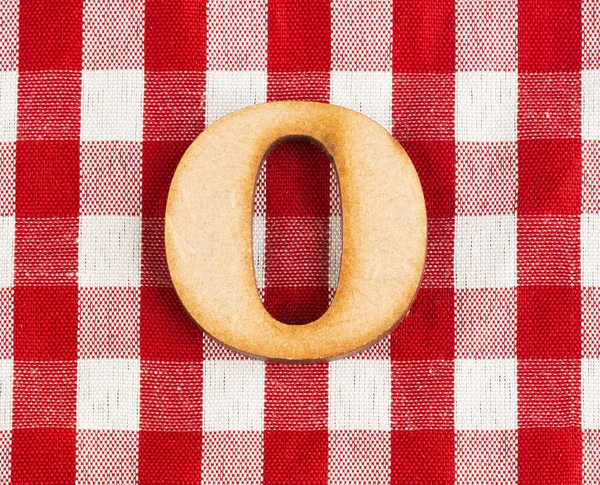 Letter O of the alphabet - Red checkered fabric tablecloth.