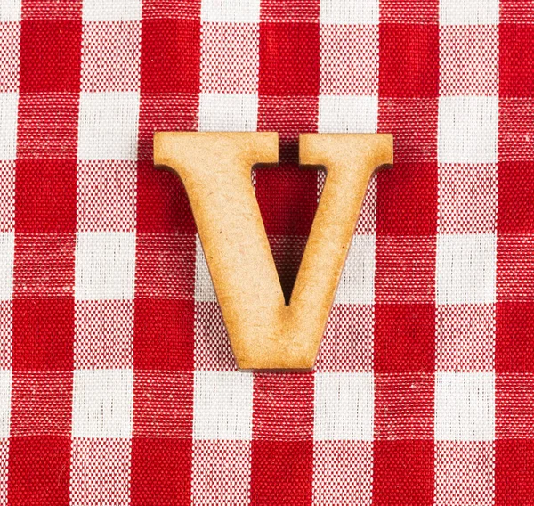 Letter V of the alphabet - Red checkered fabric tablecloth.