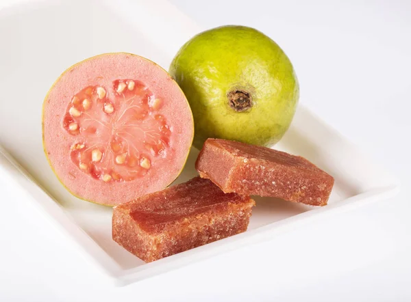 Guava fruit and paste on a white square plate