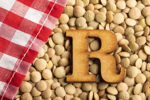 Letter R, Lentils with checkered napkin - Top view