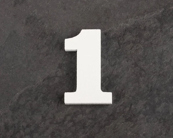 Número 1 - Figura en blanco sobre fondo gris. Vista superior —  Fotos de Stock