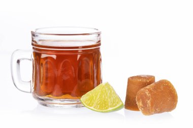 Fresh homemade Aguapanela, Agua de Panela or Aguadulce, a popular Latin American sweet drink made of panela unrefined whole cane sugar boiled in water, served warm or cold with lime clipart