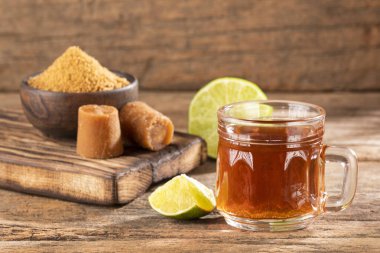 Fresh homemade Aguapanela, Agua de Panela or Aguadulce, a popular Latin American sweet drink made of panela unrefined whole cane sugar clipart