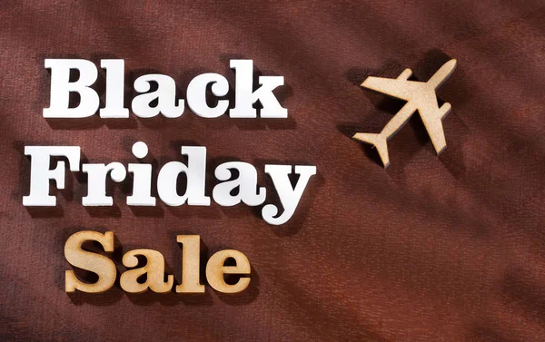 Flights in promotion - Black friday sale. Word in wooden letters