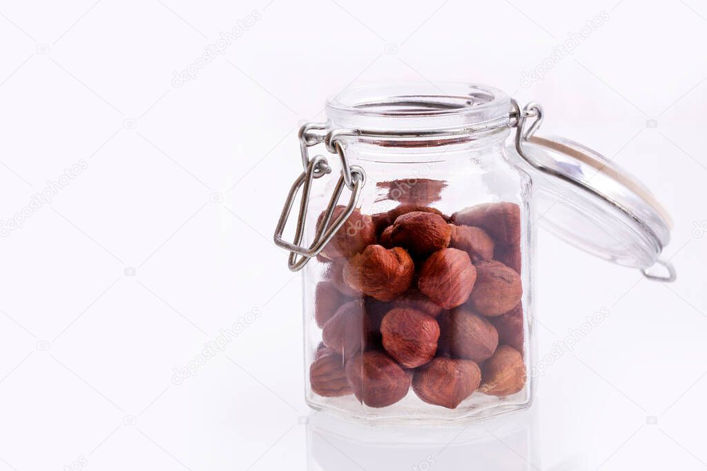 Hazelnut nuts in the glass jar - Corylus avellana