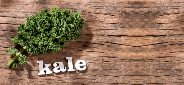 Word kale in letters with organic leaves - Brassica oleracea var.